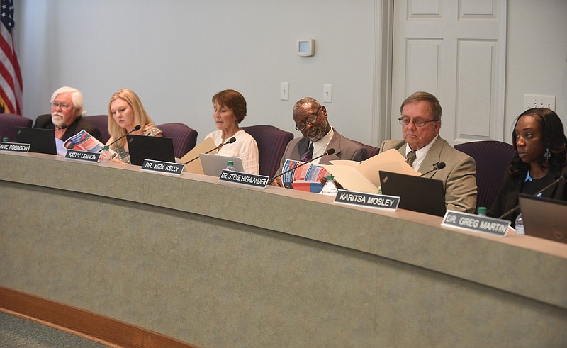 Hamilton County Board of Education members study information packets during their meeting in September.