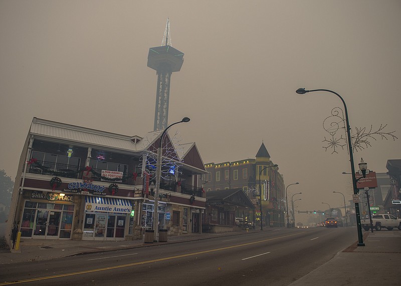 Thick smoke from area forest fires hovers over downtown Gatlinburg on Monday.