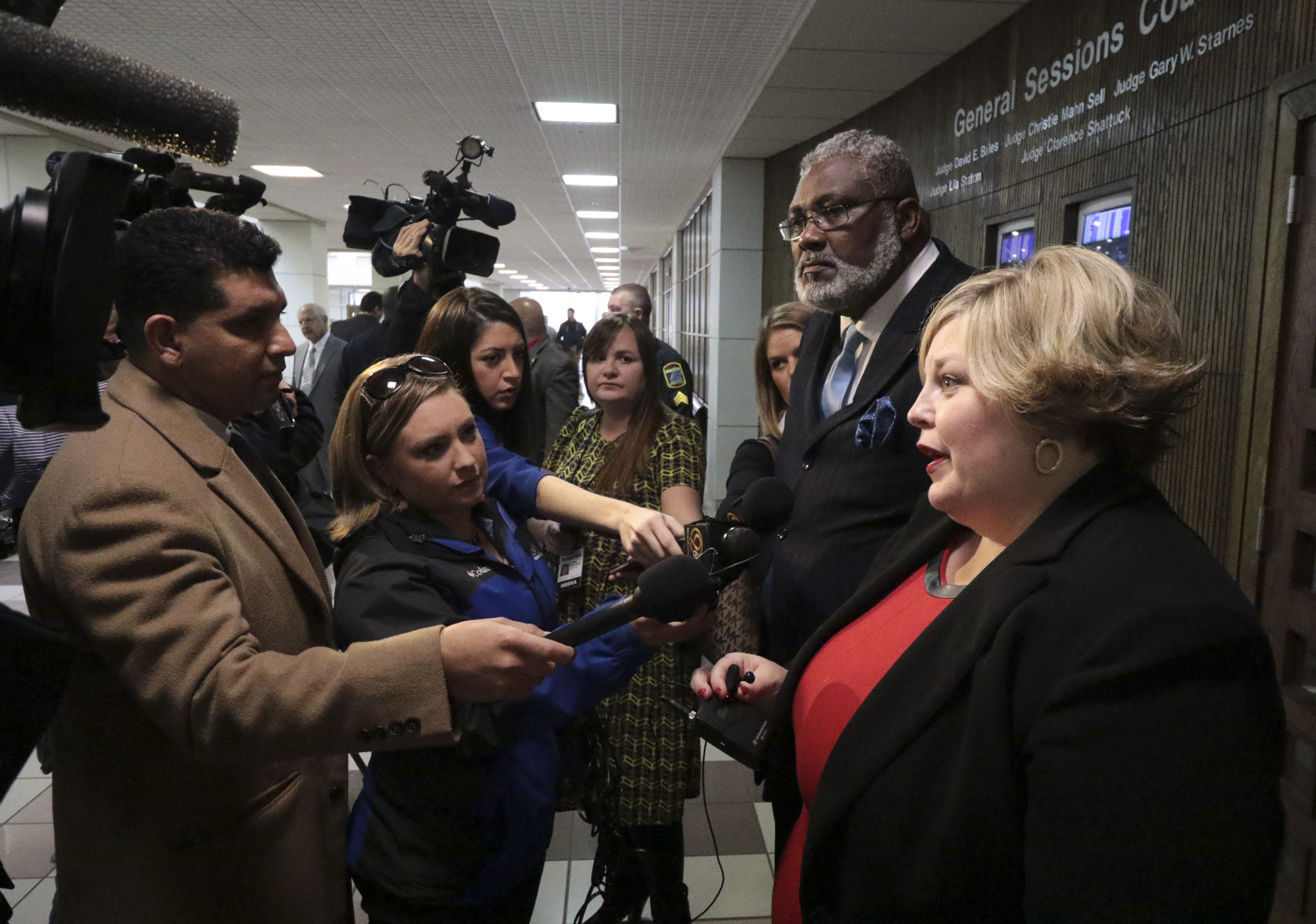 Staff Photo by Dan Henry / The Chattanooga Times Free Press- 11/29/16. Media surround as Amanda Dunn speaks on behalf of Johnthony Walker, the bus driver charged in the school bus crash on Talley Road that left six children dead and others injured on November 21, after he made his first appearance in Judge Lila Statom's courtroom on Tuesday, November 29, 2016.