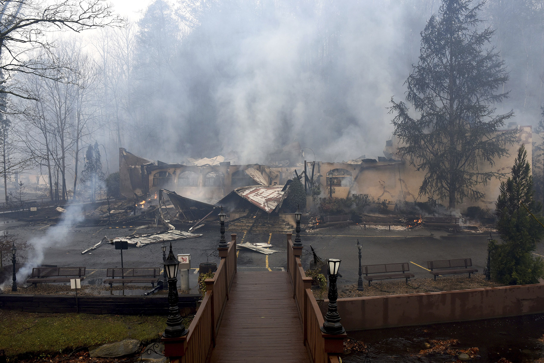 The Alamo Steakhouse is damaged from the wildfires around Gatlinburg, Tenn., on Tuesday, Nov. 29, 2016. Rain had begun to fall in some areas, but experts predicted it would not be enough to end the relentless drought that has spread across several Southern states and provided fuel for fires now burning for weeks in states including Tennessee, Georgia and North Carolina. (Michael Patrick/Knoxville News Sentinel via AP)