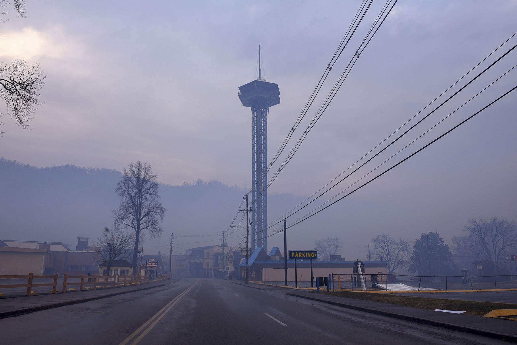 Smoke from wildfires fill the air around Gatlinburg, Tenn., on Tuesday, Nov. 29, 2016. Rain had begun to fall in some areas, but experts predicted it would not be enough to end the relentless drought that has spread across several Southern states and provided fuel for fires now burning for weeks in states including Tennessee, Georgia and North Carolina. (Michael Patrick/Knoxville News Sentinel via AP)