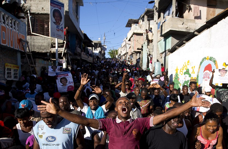 
              Supporters of presidential candidate Maryse Narcisse, from Fanmi Lavalas political party, chant victory slogans during a protest in Port-au-Prince, Haiti, Monday, Nov. 28, 2016.  Before election results have been announced, supporters of Narcisse assert their candidate has won, and that only electoral fraud would keep her from office. (AP Photo/Dieu Nalio Chery)
            