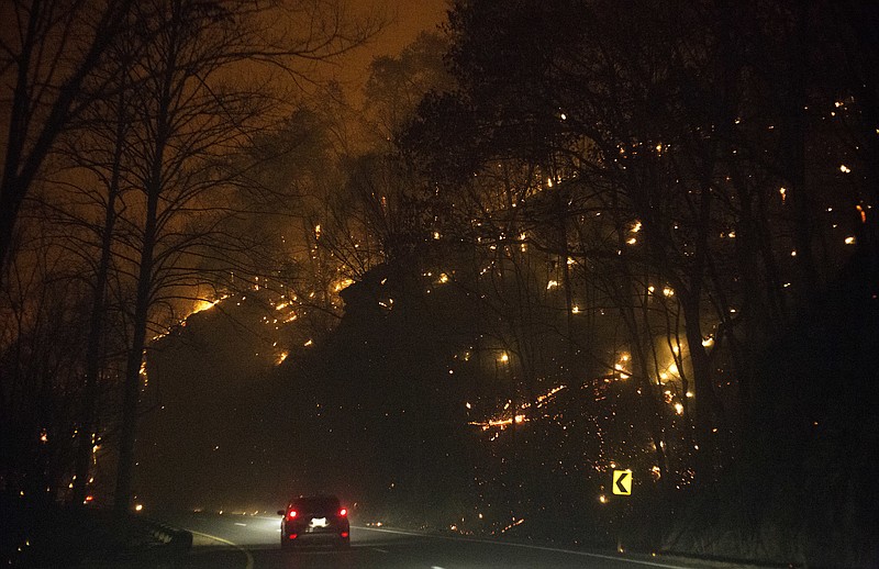 
              Fire erupts on both side of Highway 441 between Gatlinburg and Pigeon Forge, Tenn., Monday, Nov. 28, 2016. In Gatlinburg, smoke and fire caused the mandatory evacuation of downtown and surrounding areas, according to the Tennessee Emergency Management Agency. (Jessica Tezak/Knoxville News Sentinel via AP)
            