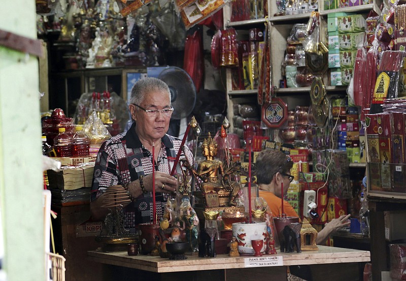 
              In this Monday, Nov. 28, 2016 photo, Indonesian ethnic Chinese Jhony Tan prays at his store at the Chinatown in Jakarta, Indonesia.  The capital of Muslim-majority Indonesia is on edge ahead of what is expected to be a second massive protest on Friday by conservative Muslims against its Christian governor and no group more so than its Chinese minority.  They have reason to be concerned. The movement against the governor, who is being prosecuted for allegedly insulting the Quran, has overflowed with racial slurs against his Chinese ancestry and has awakened painful memories of deadly anti-Chinese riots in 1998. (AP Photo/Achmad Ibrahim)
            