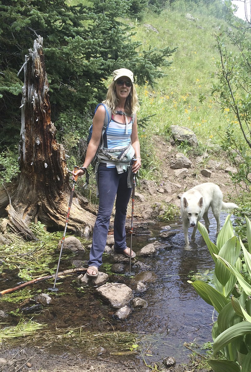 Dagny McKinley, an author, blogger and photographer, is one of a number of Americans who has sometimes chosen to spend major holidays alone, as a way of decompressing from busy lives, relaxing and reflecting. Her routine on a birthday, Christmas or Thanksgiving spent solo often includes a hike with her dog, Alma May. (Tom Thurston via AP)