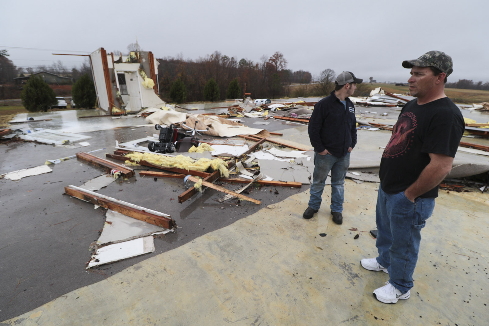 Staff Photo by Dan Henry / The Chattanooga Times Free Press- 11/30/16. Family members who wished to not be identified look at what's left after a suspected tornado hit their parent's day care in Ider, AL., on Wednesday, Nov 30, 2016. The overnight storm also destroyed structures and killed three people in the neighboring town of Rosalie, AL.
