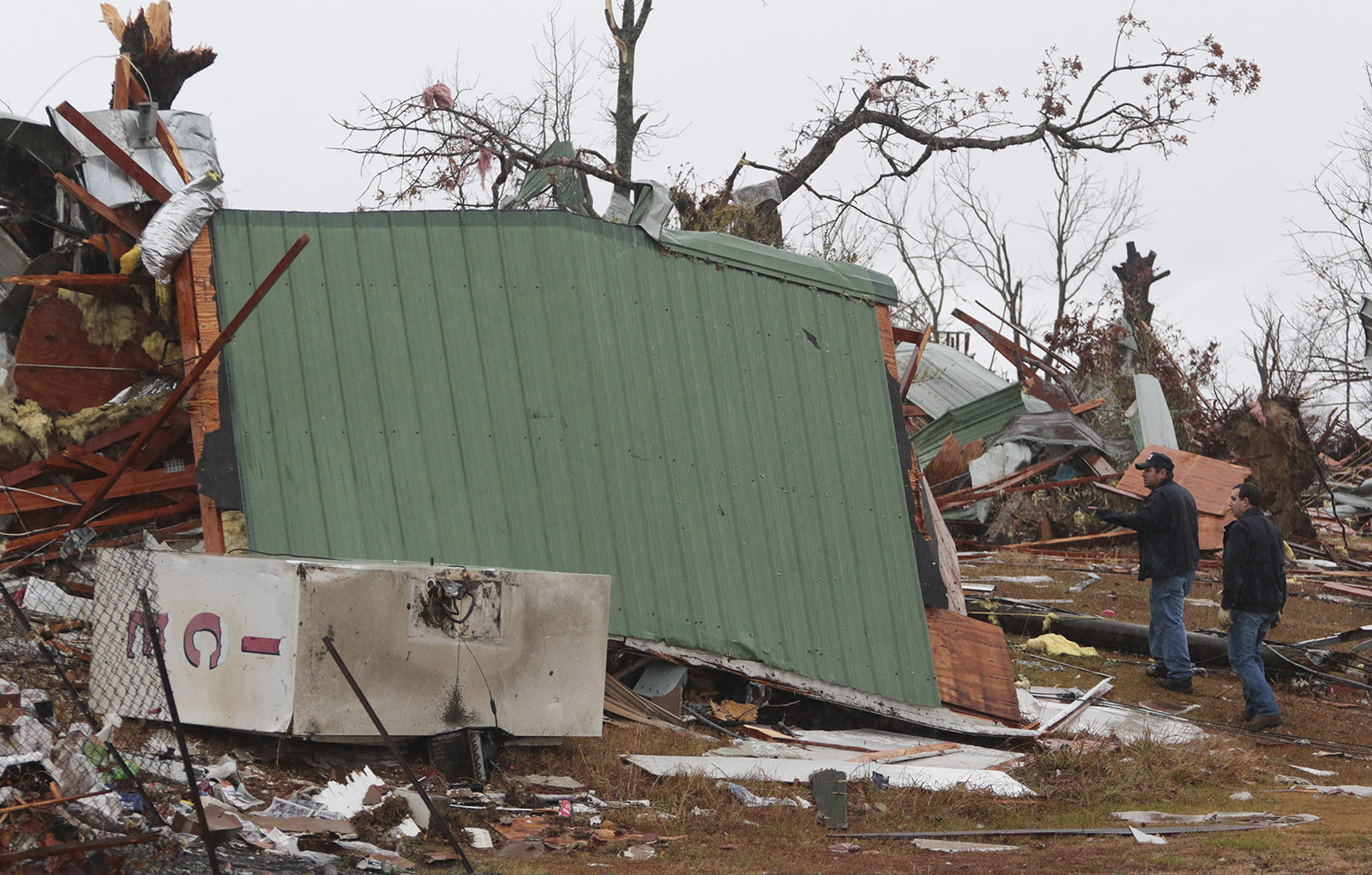 Staff Photo by Dan Henry / The Chattanooga Times Free Press- 11/30/16. Community members search survey damage in Rosalie, AL, on Wednesday, Nov 30, 2016 where a suspected tornado touched down overnight killing three from the community