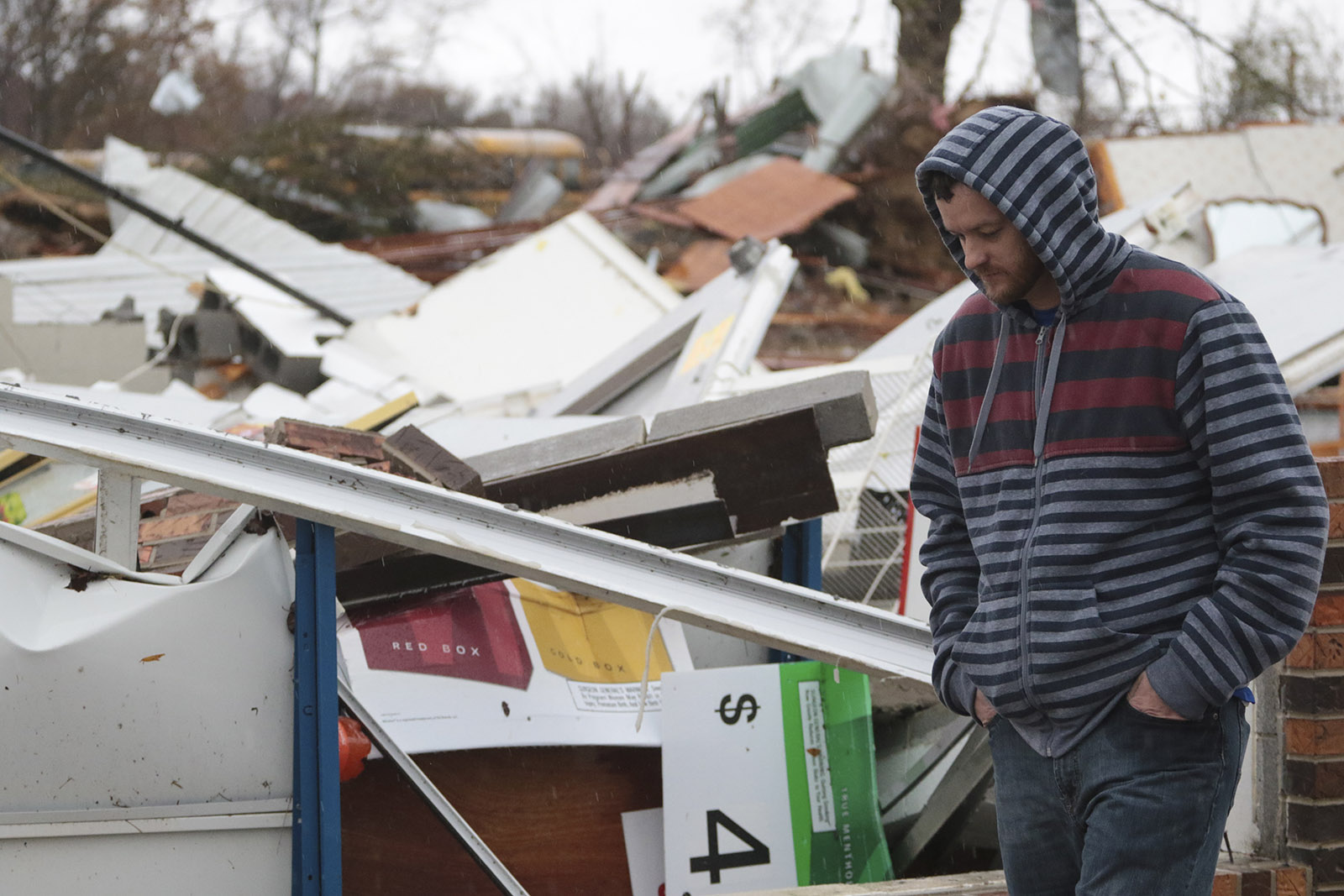 Staff Photo by Dan Henry / The Chattanooga Times Free Press- 11/30/16. Chris Summerford, walks past the demolished Rosalie Plaza Grocery. Summerford lost three family members overnight to a suspected tornado that rocked the Rosalie, AL, community on Wednesday, Nov 30, 2016.