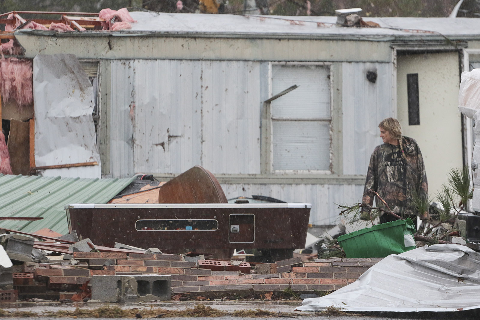 Staff Photo by Dan Henry / The Chattanooga Times Free Press- 11/30/16. A volunteer surveys the damage done to the Rosalie Plaza Grocery in Rosalie, AL, on Wednesday, Nov 30, 2016 where a suspected tornado touched down overnight killing three from the community.