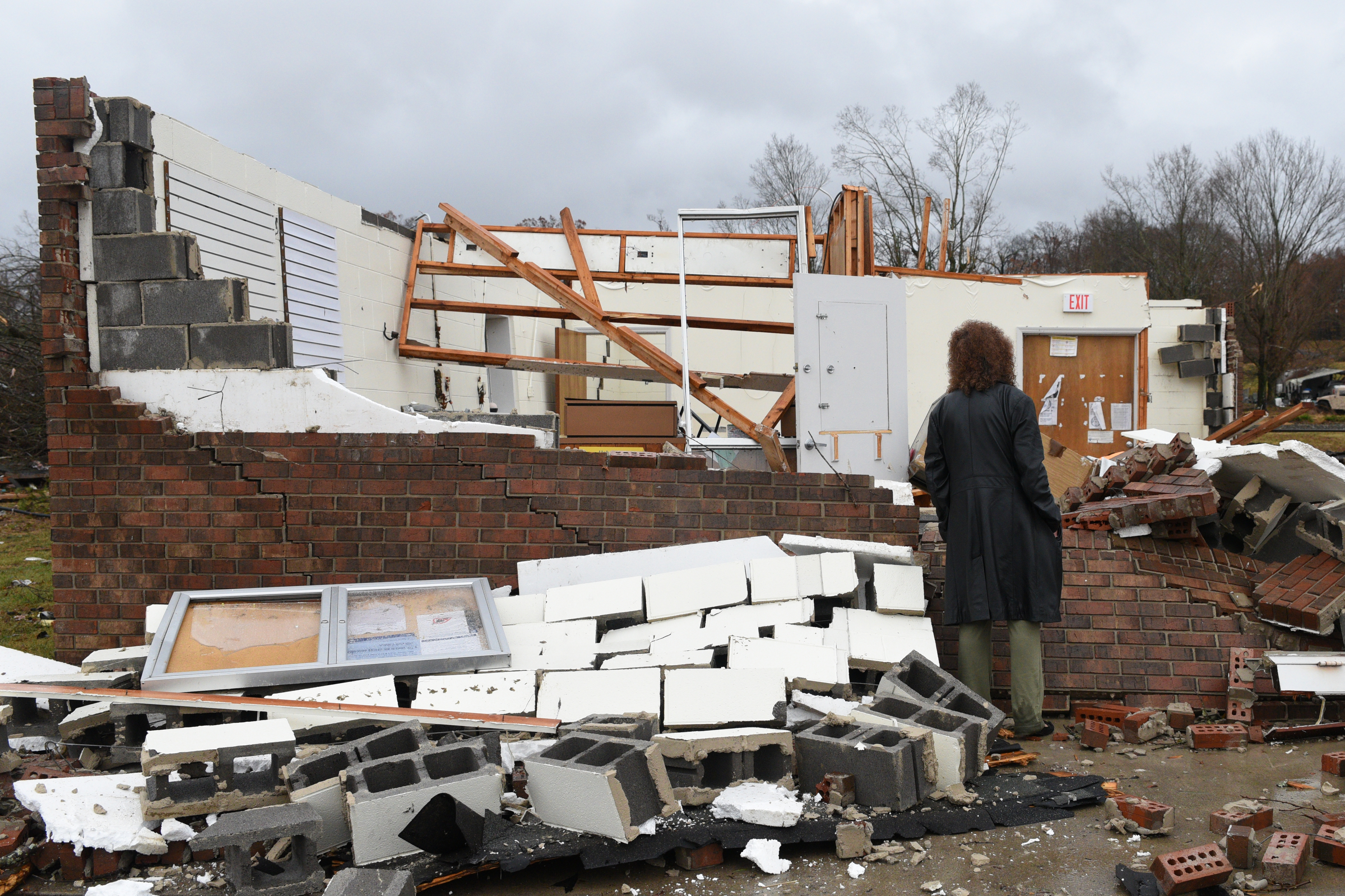 Lydia Nail, who worked at the Ocoee Post Office for 20 years, and lives next door, looks at the remains Wednesday, Nov. 30, 2016 in Polk County after a tornado swept through the area early Wednesday. Her home has some leaks from missing shingles, but did not suffer major damage.