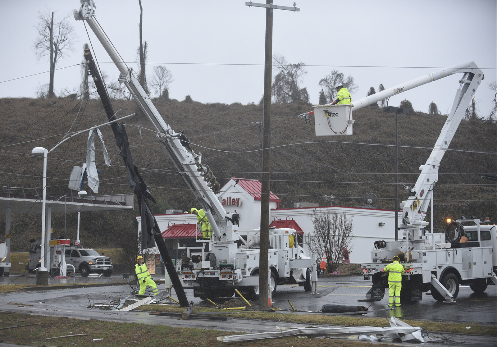Crews work on power lines on South White Street in Athens, Tenn., Wednesday, Nov. 30, 2016 after a tornado swept through the area early Wednesday morning.