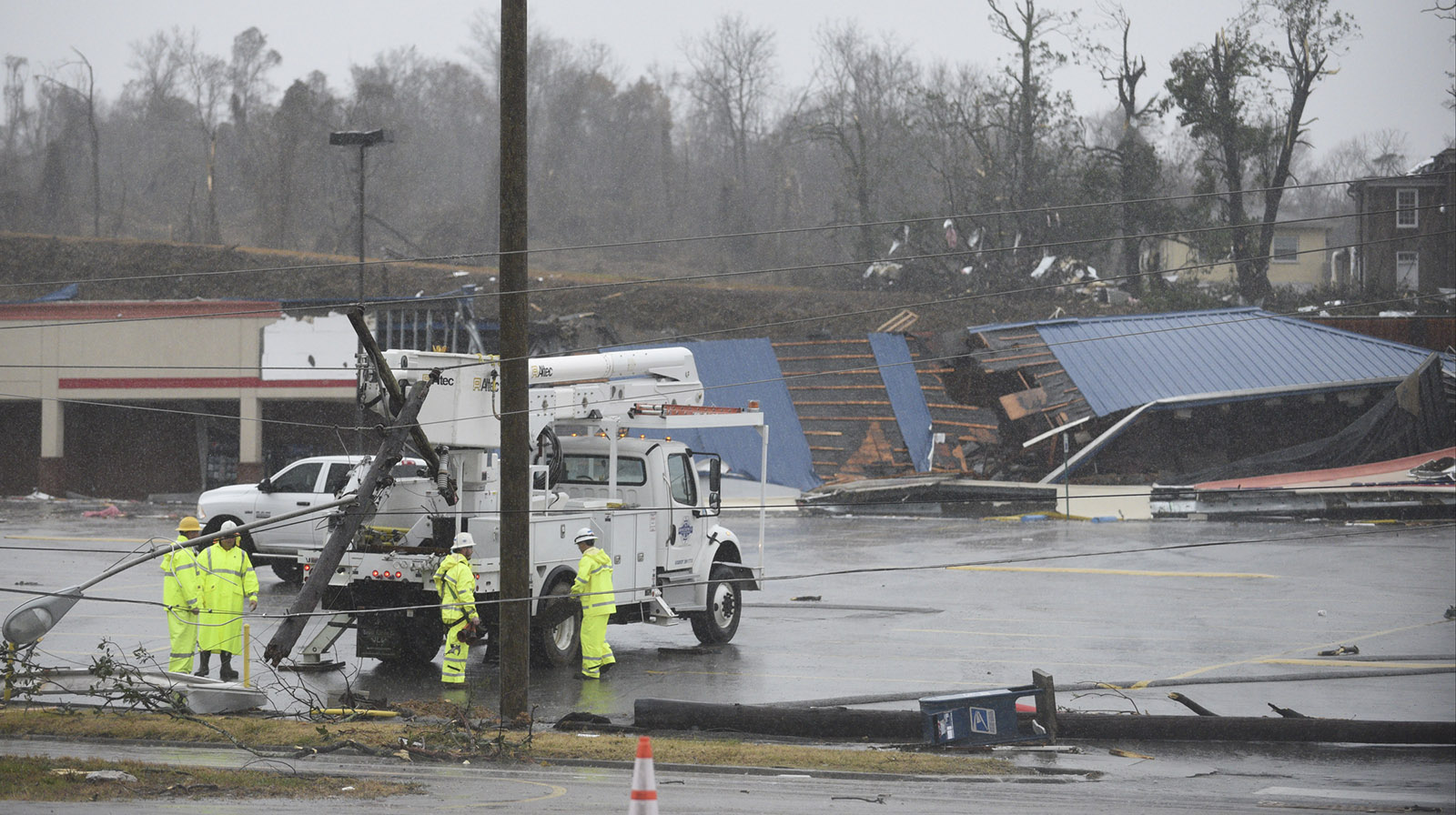 Crews work on power lines on South White Street in Athens, Tenn., Wednesday, Nov. 30, 2016 after a tornado swept through the area early Wednesday morning.