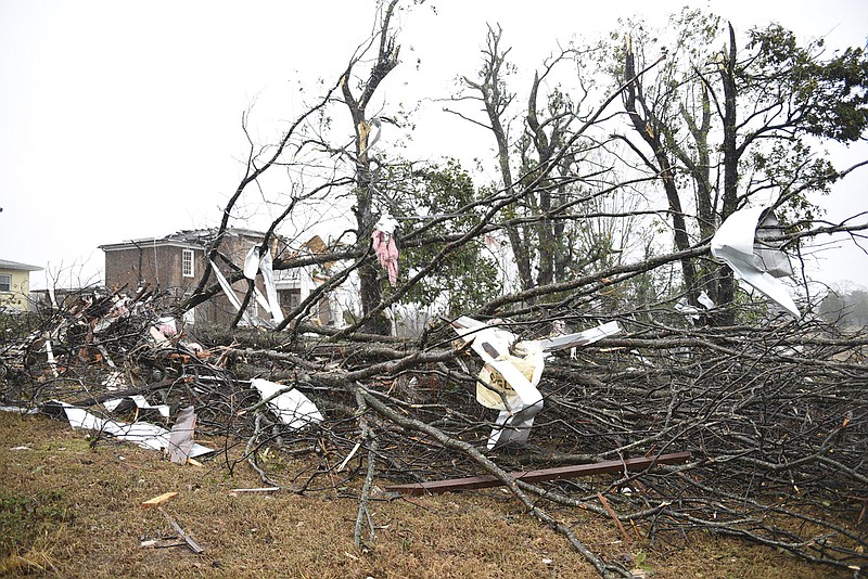 Debris litters Lisa and Jim Long's yard in Athens, Tenn. Wednesday, Nov. 30, 2016 after a tornado swept through early Wednesday morning.