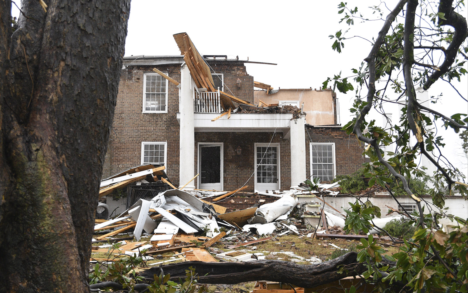 Debris litters Lisa and Jim Long's yard in Athens, Tenn. Wednesday, Nov. 30, 2016 after a tornado swept through early Wednesday morning. The couple was refurbishing the historic home, while living in the adjacent house.