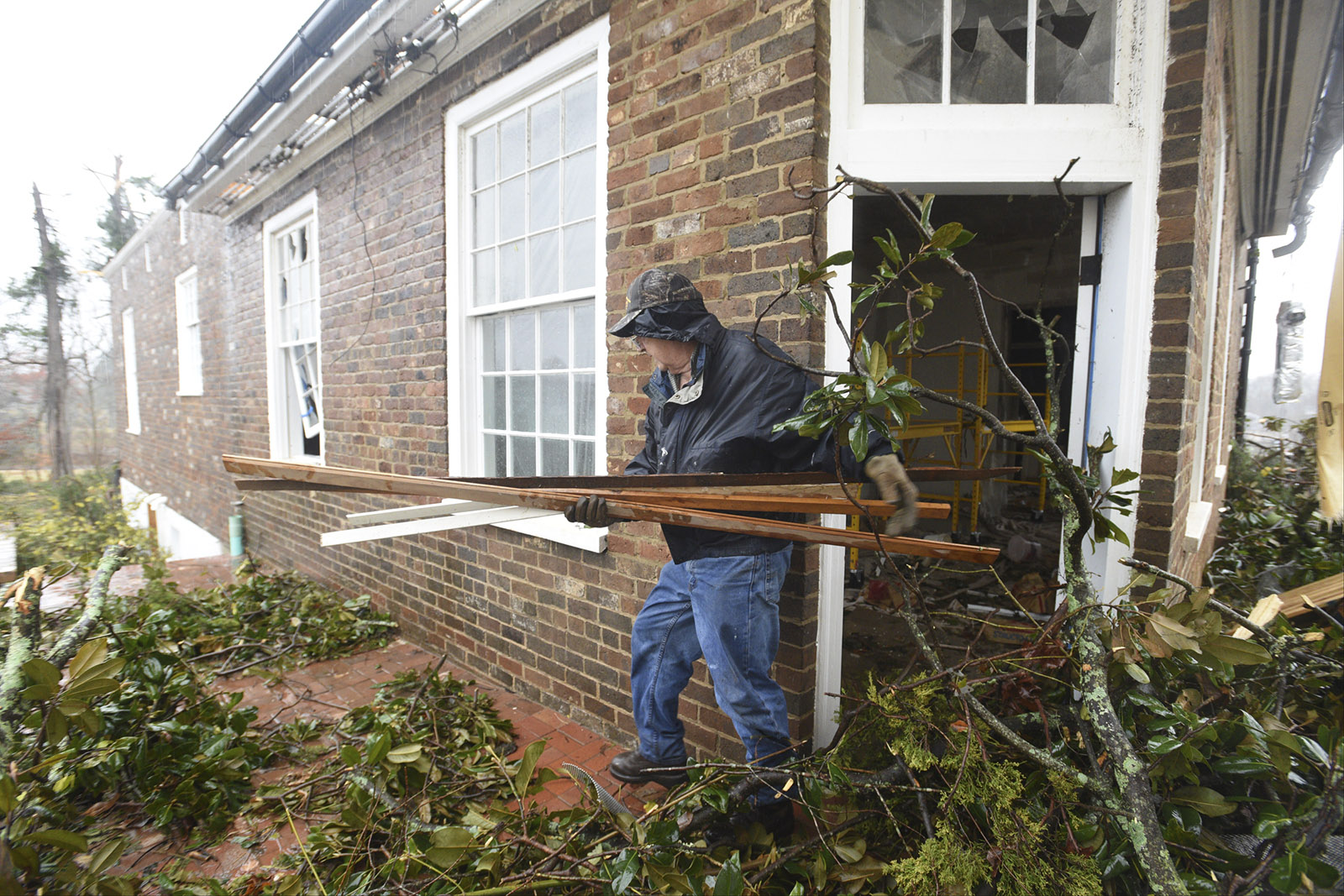 R. C. Truelove carries would out of the historic home that Lisa and Jim Long were refurbishing in Athens, Tenn. Wednesday, Nov. 30, 2016 after a tornado swept through early Wednesday morning. The couple was living in the adjacent house while working on the old home.