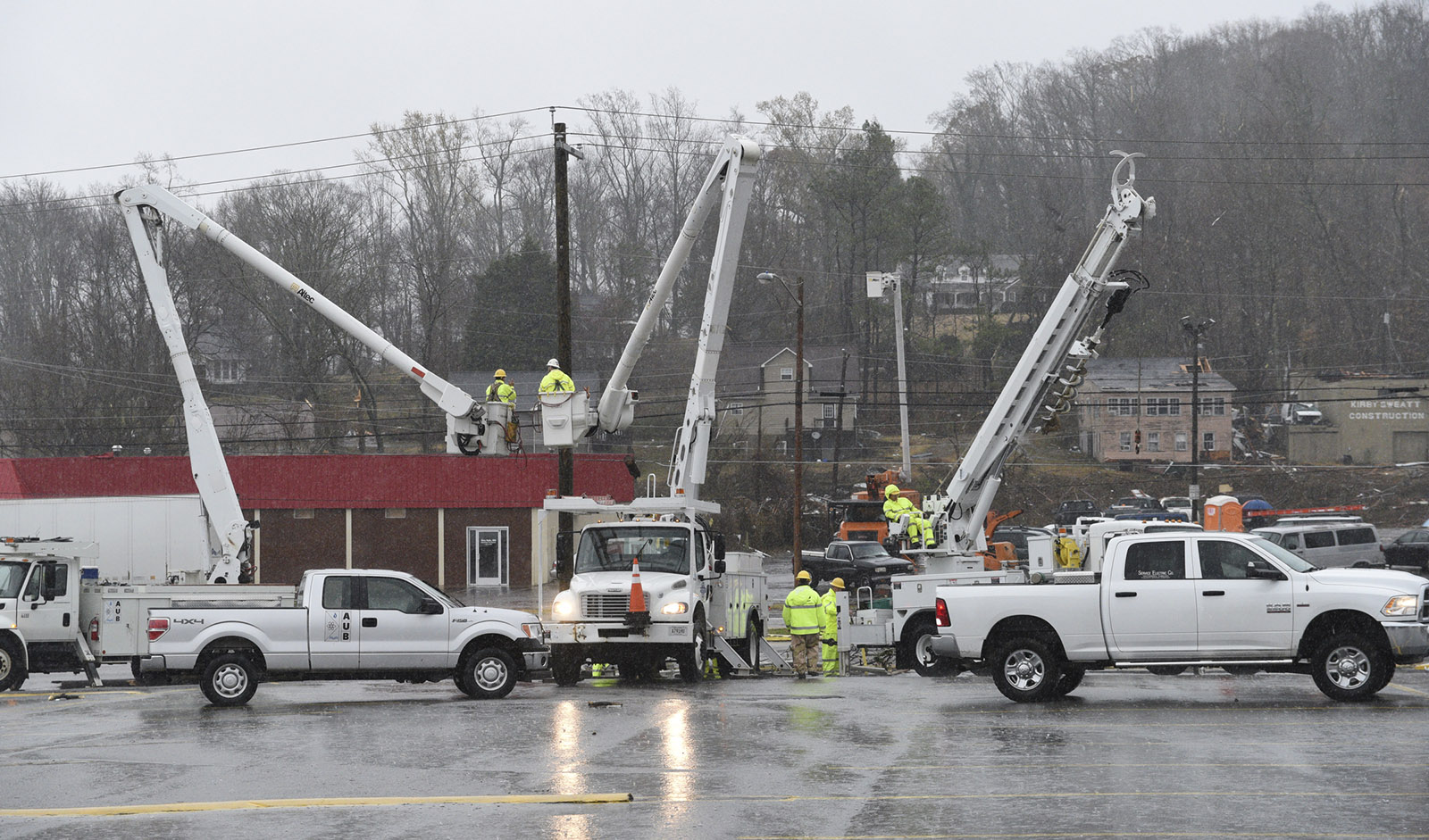 Crews work on power lines on South White Street in Athens, Tenn., Wednesday, Nov. 30, 2016 after a tornado swept through the area early Wednesday morning.