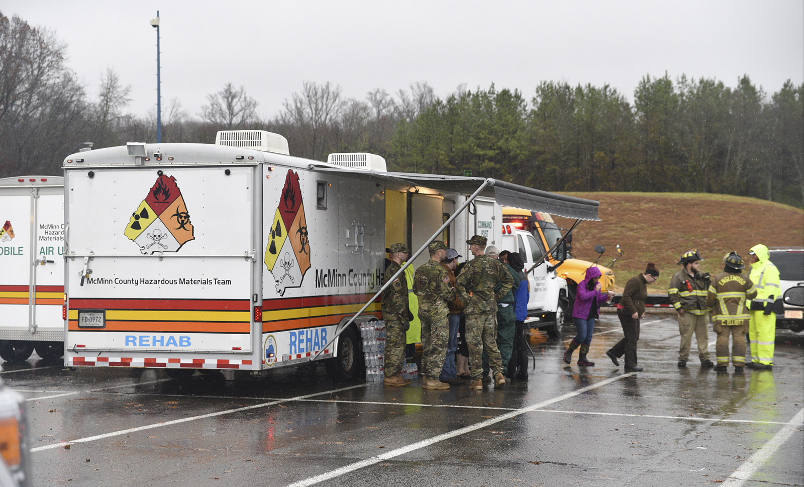 People gather around the command post near Highway 307 in Athens, Tenn., Wednesday, Nov. 30, 2016 while working the area where a tornado touched down early Wednesday.