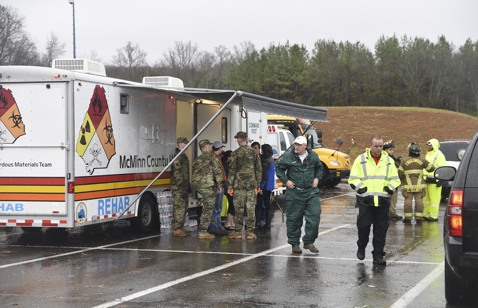 People gather around the command post near Highway 307 in Athens, Tenn., Wednesday, Nov. 30, 2016 while working the area where a tornado touched down early Wednesday.