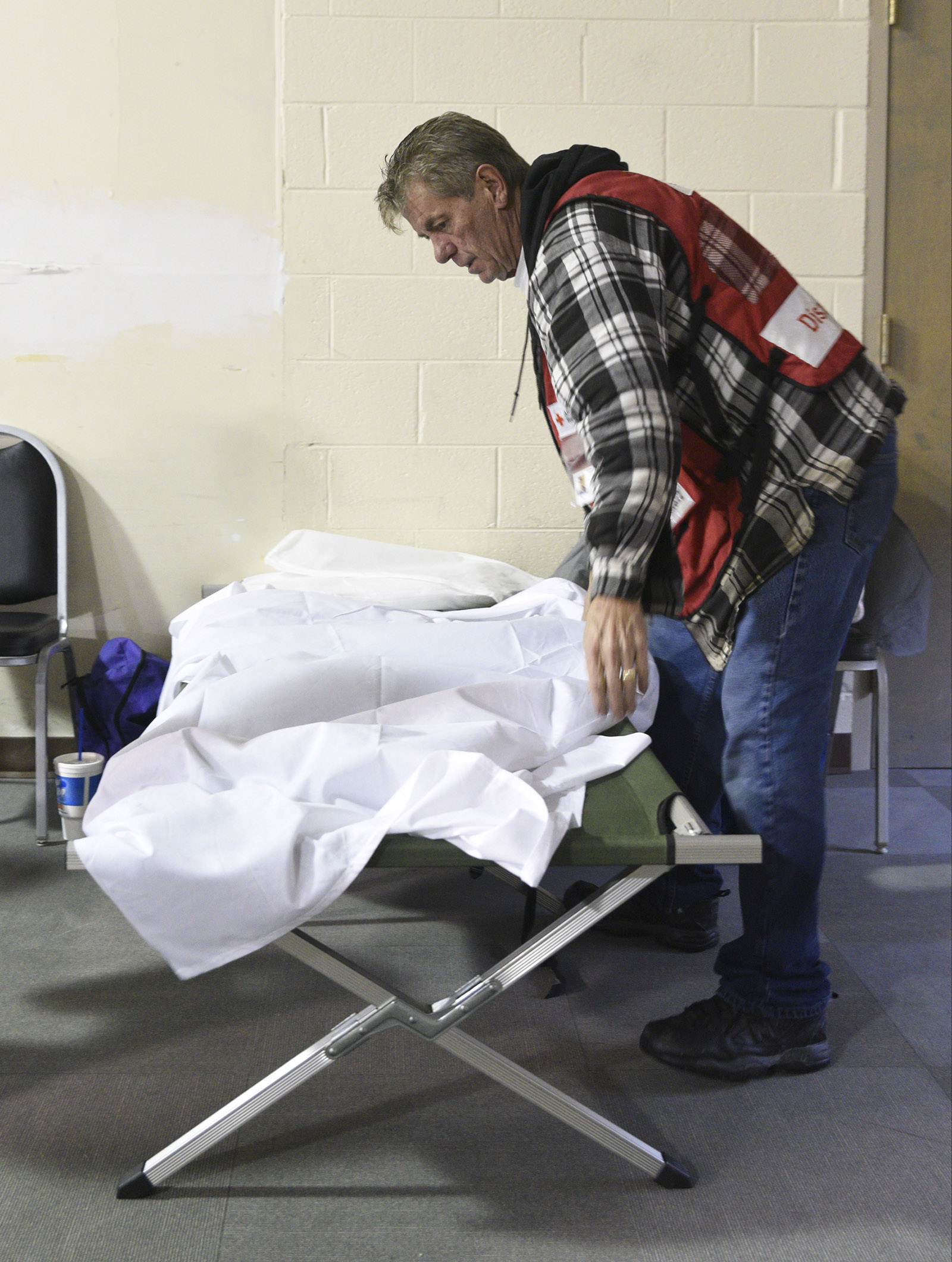 Joe Brzezowski makes up a cot at Keith Memorial United Methodist Church in Athens, Tenn., Wednesday, Nov. 30, 2016 while preparing the church to shelter victims of the tornado that touched down early Wednesday morning.