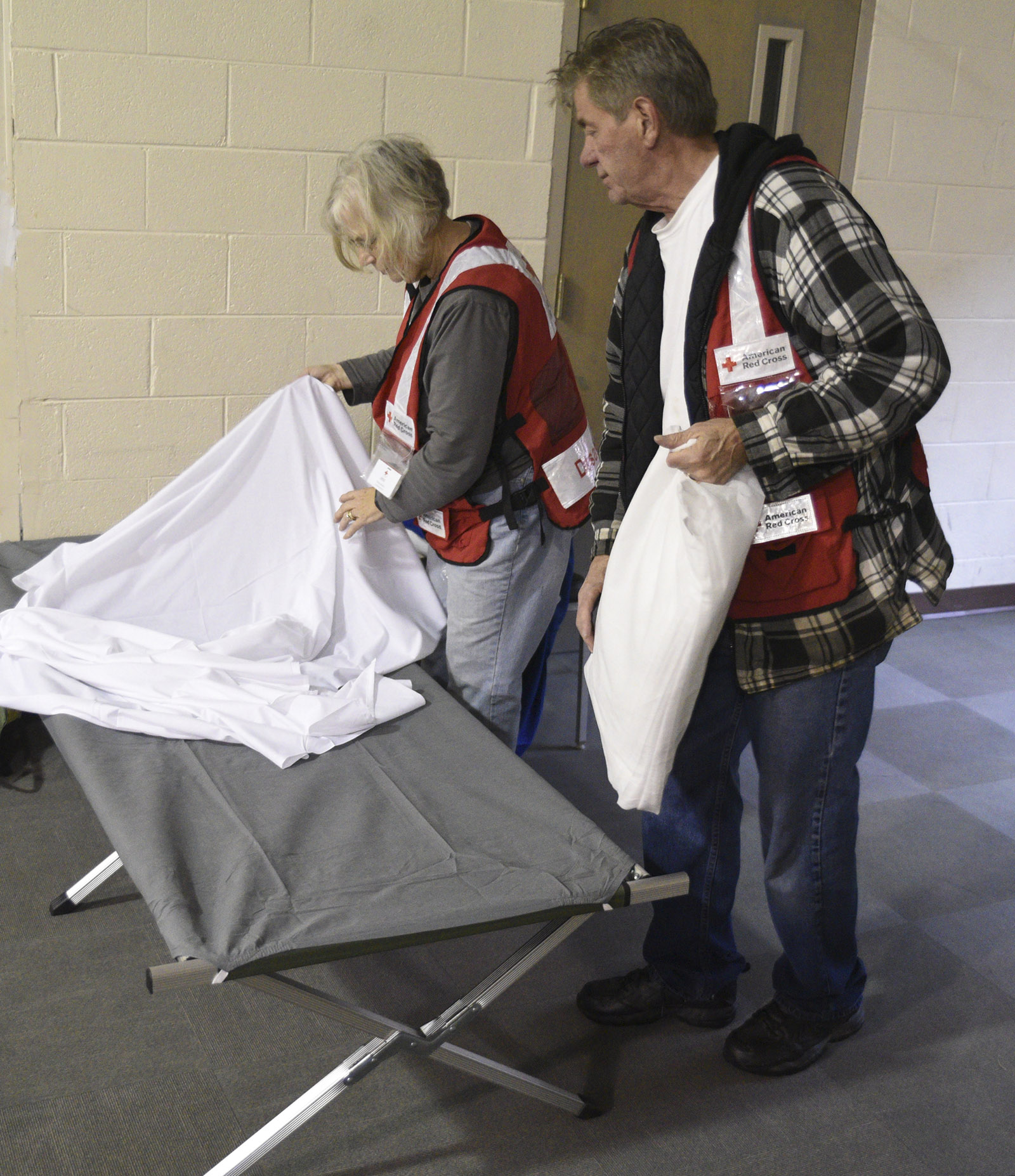 Joe Brzezowski, right, and Donna Murray make up a cot at Keith Memorial United Methodist Church in Athens, Tenn., Wednesday, Nov. 30, 2016 while preparing the church to shelter victims of the tornado that touched down early Wednesday morning.