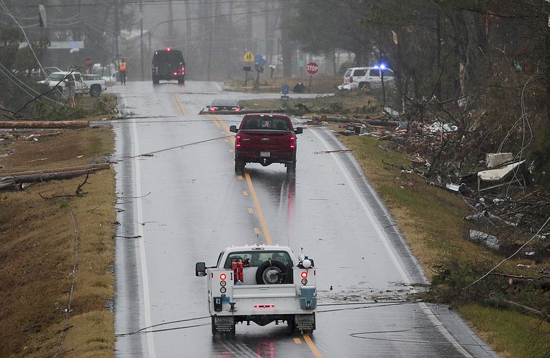Emergency and utility personnel work a one-plus mile stretch of Rosalie, Ala., on Wednesday, Nov 30, 2016, where a tornado touched down overnight killing three from the community.
