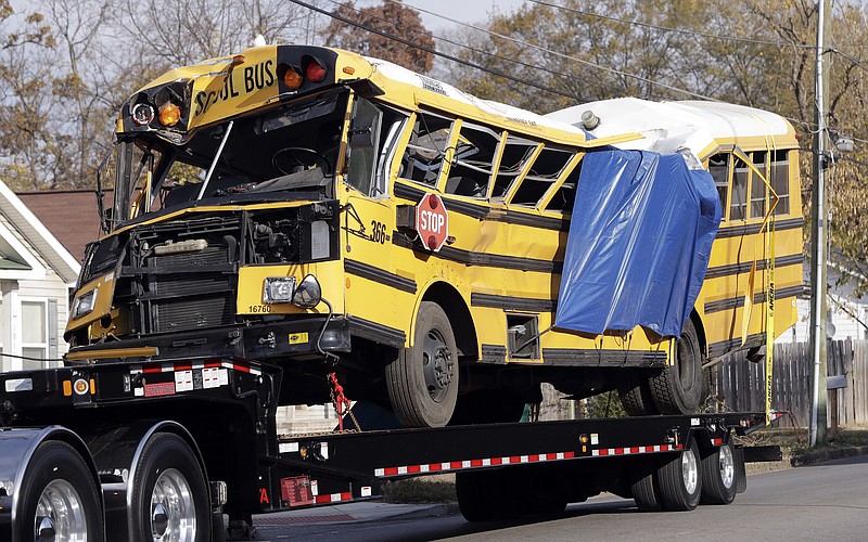 
              FILE - In a Tuesday, Nov. 22, 2016 file photo, a school bus is carried away, in Chattanooga, Tenn, from the site where it crashed on Monday. Attorney Amanda Dunn says she anticipates bus driver Johnthony Walker will plead not guilty if a grand jury indicts him. He's charged with five counts of vehicular homicide. Police say another count will be added. (AP Photo/Mark Humphrey, File)
            