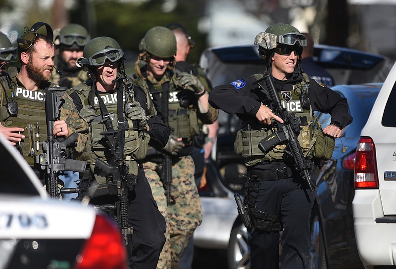 Officers and SWAT team members fill Wheeler Avenue Dec. 1, 2016, while searching for a man who shot a Chattanooga police officer three times as he was checking an abandoned building near the intersection of Glenwood Avenue and Mission Avenue. The officer was treated at Erlanger hospital and was released.