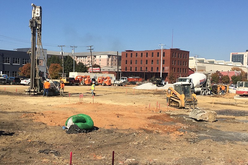 Workers perform drilling work for site preparation on a 210-unit apartment complex being built in the 1400 block of Chestnut Street on the Southside.