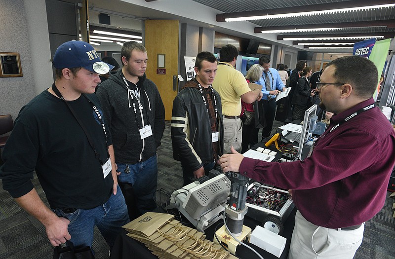 Ridgeland High School students Dallas Dempsey, Robert Murray and Noah Goodson, from left, talk with controls engineer Matt Chapman at Astec Inc., Tuesday, Nov. 29, 2016 during a job fair.