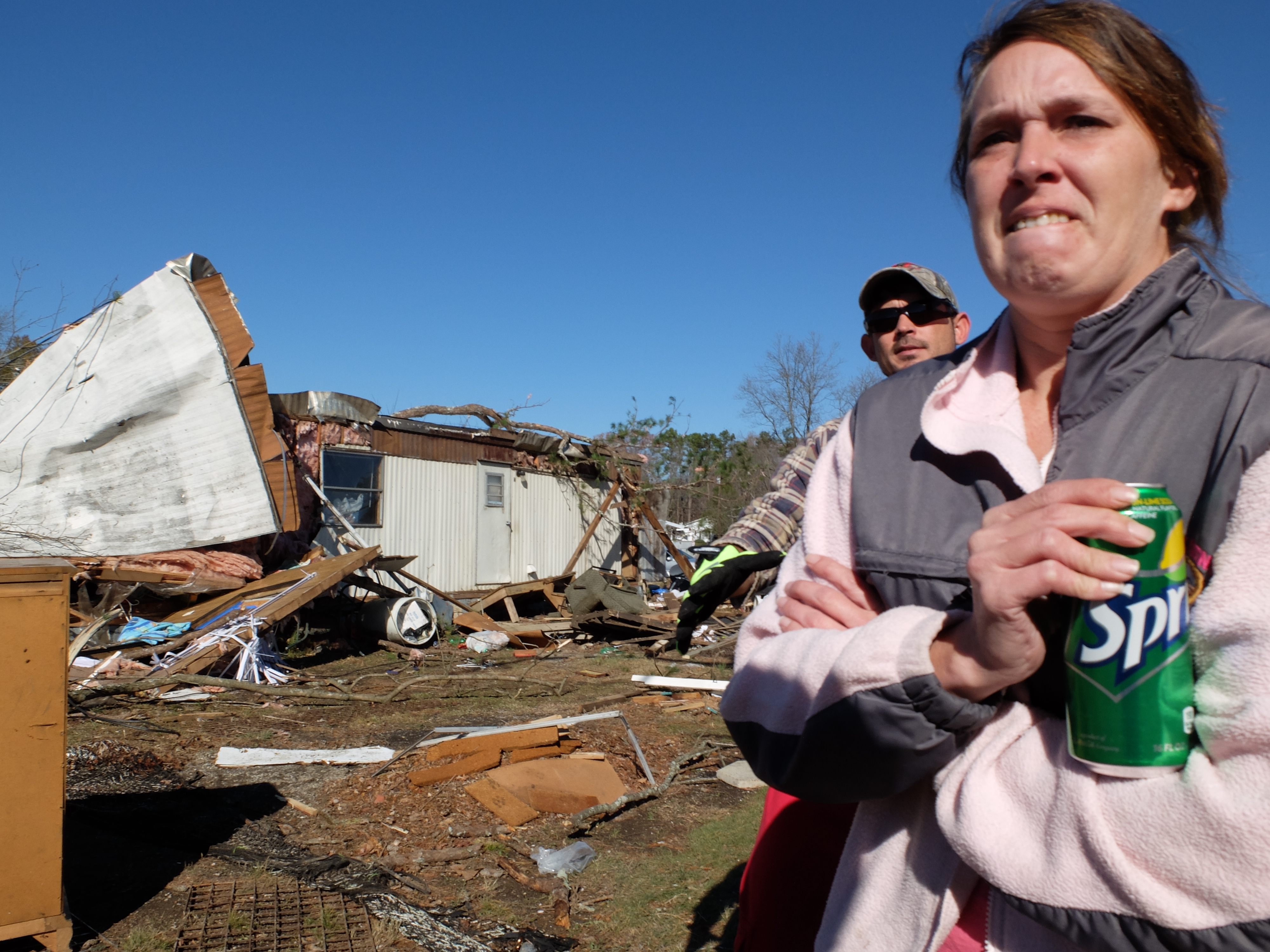 Ben Young and his wife, Jennifer stand outside their single wide trailer where they survived Wednesday's tornado with their two children, Cullyn Young and Curtis Moses, at 2:30 a.m. in Ocoee, Tenn.