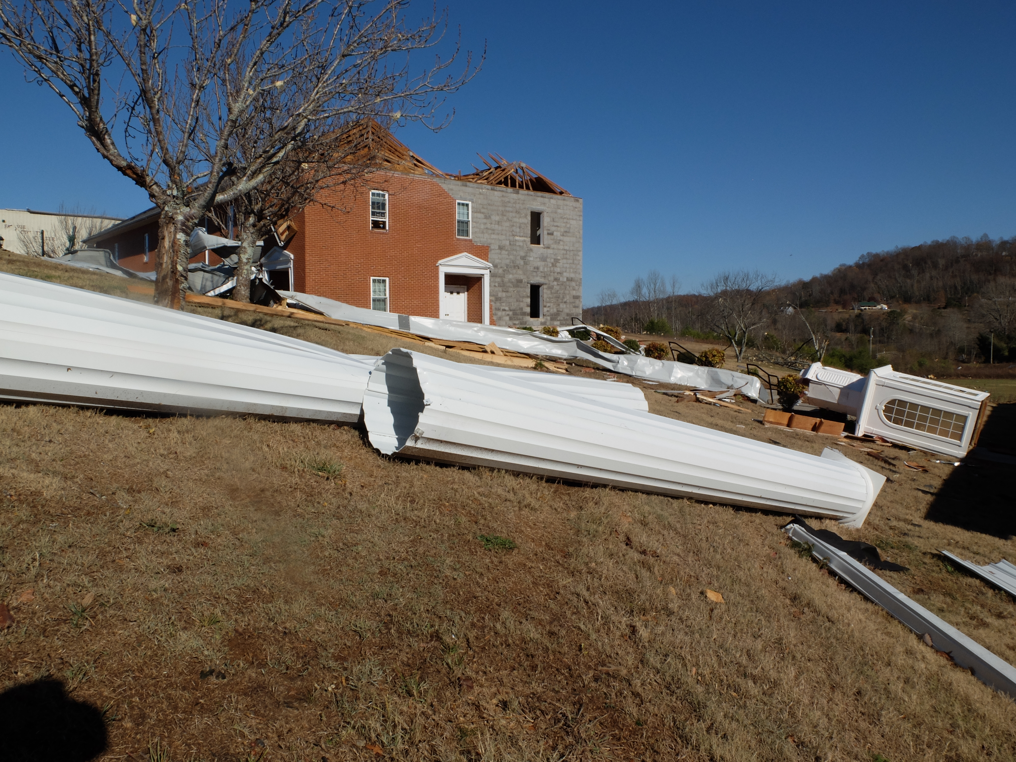 Fairview Baptist Church facade columns and a portion of the steeple lay on the ground following the tornado struck early Wednesday on the campus of Fairview Christian Academy in Athens, Tenn.