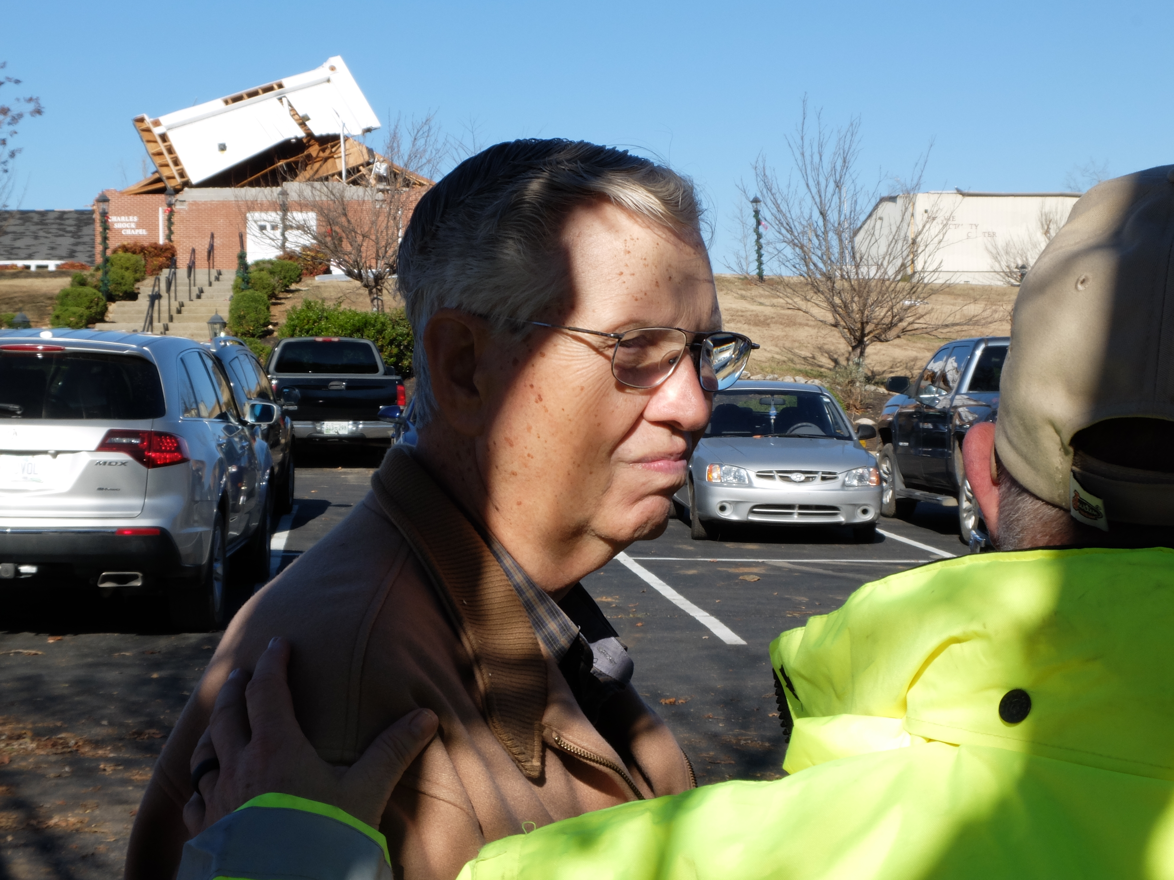 Fairview Baptist Church Pastor Jack Scallions listens to a safety official on the campus of the Fairview Christian Academy early Thursday just east of Athens, Tenn. Pastor Scallions has been the leader of his flock for 43-years at this location. The church over his shoulder was the original church from 63 years ago.