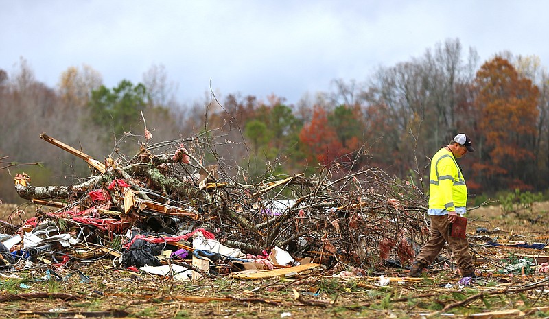 
              Bob Wright looks for personal belongings after a suspected tornado ripped through the town of Rosalie, killing three of his brother's family members, Wednesday, Nov. 30, 2016, in Rosalie, Ala. (AP Photo/Butch Dill)
            