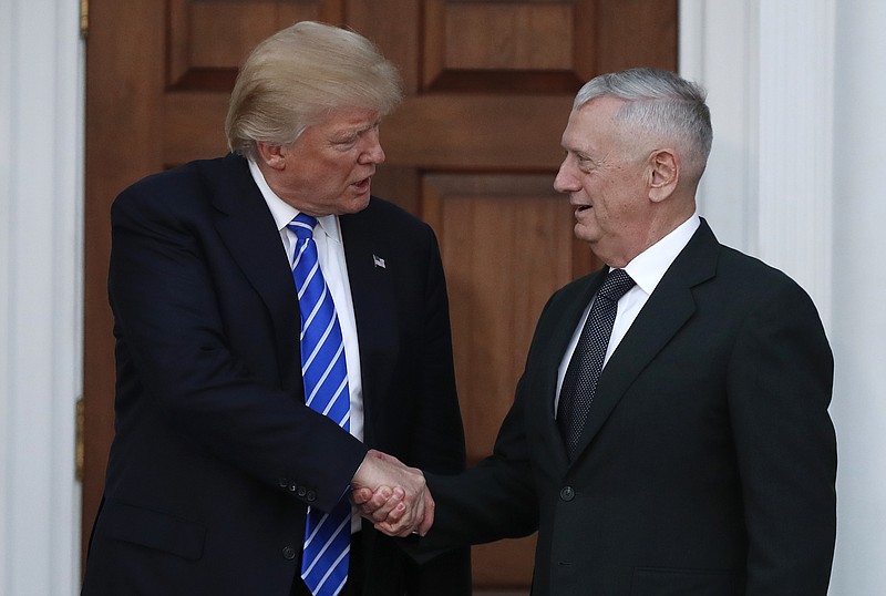 
              FILE - In this Nov. 19, 2016, file photo, President-elect Donald Trump shakes hands with retired Marine Corps Gen. James Mattis as he leaves Trump National Golf Club Bedminster clubhouse in Bedminster, N.J. Trump said at a rally on Dec. 1, that he will nominate Mattis as defense secretary. (AP Photo/Carolyn Kaster, File)
            