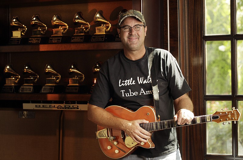 In this Aug. 16, 2011 photo, Vince Gill is shown with some of his Grammy awards at his home in Nashville, Tenn.