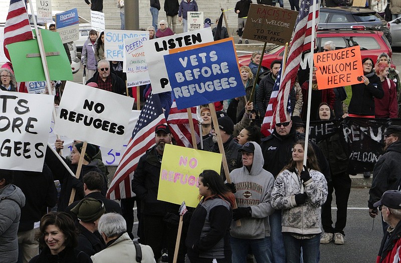 Protesters on opposing sides of the Syrian refugee resettlement issue rally in front of the state capitol in Olympia, Wash., last year.