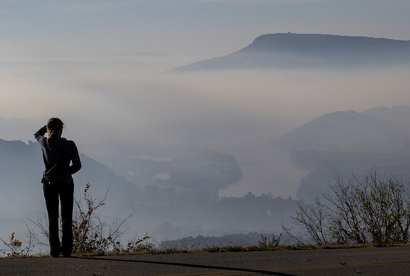 Staff Photo by Dan Henry / The Chattanooga Times Free Press - Grace Mynatt looks off toward Lookout Mountain as smoke fills the Tennessee Valley from wildfires.