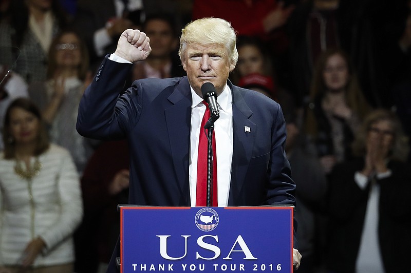 
              President-elect Donald Trump raises his fist as he speaks during the first stop of his post-election tour, Thursday, Dec. 1, 2016, in Cincinnati. (AP Photo/John Minchillo)
            