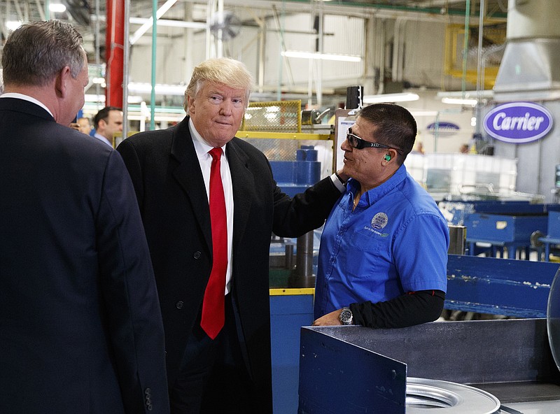 
              President-elect Donald Trump talks with workers during a visit to the Carrier factory, Thursday, Dec. 1, 2016, in Indianapolis, Ind. (AP Photo/Evan Vucci)
            