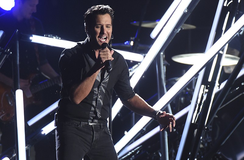 
              FILE - In this Nov. 2, 2016, file photo, Luke Bryan performs "Move" at the 50th annual CMA Awards at the Bridgestone Arena in Nashville, Tenn. Video shows Bryan slapping a heckler with his fingers while still holding the microphone during a show in Nashville on Nov. 30, 2016. Bryan then continued with the song seeming unfazed by the incident.(Photo by Charles Sykes/Invision/AP, File)
            