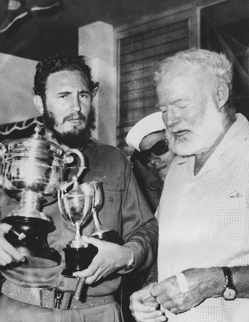 
              FILE - In this May 15, 1960 file photo, American novelist Ernest Hemingway, right, stands with Cuba's leader Fidel Castro who holds a trophy after winning the individual championship in the annual Hemingway Fishing Tournament in Havana, Cuba.  For many artists, Fidel Castro was a contradiction they never quite resolved, a man equally hard to embrace or to ignore. He was the bold revolutionary who defied the U.S. government and inspired the left worldwide and the long-winded despot who reminded them of the right-wing leaders they had traditionally opposed.  (AP Photo/File)
            