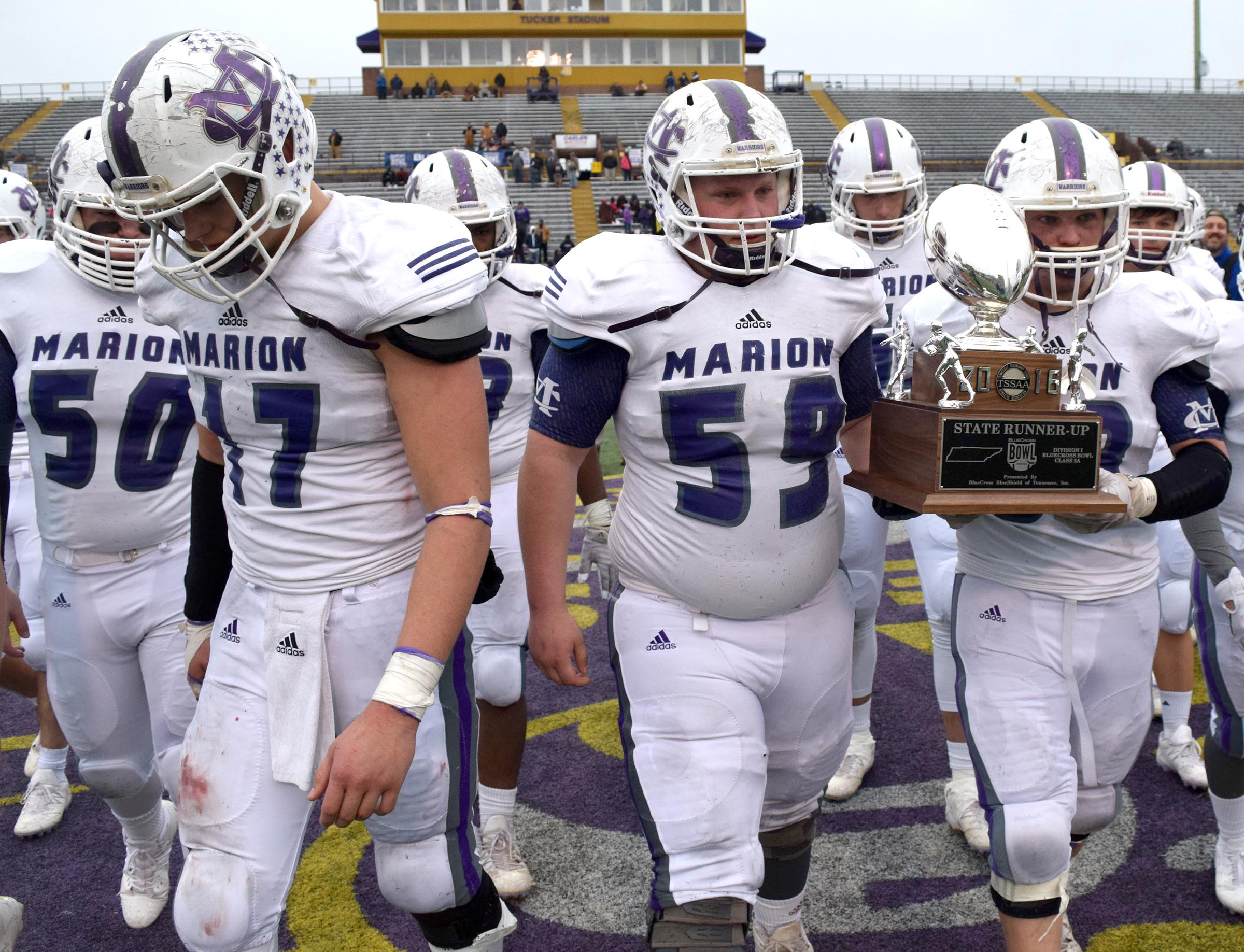 Warriors Noah Walters (50) and Alex Kirkendoll (17 leave the field as Logan Campbell (59) and Eli Morrison (58) carry the runner-up trophy. The Marion County Warriors faced the Memphis Trezevant Bears in the Class AA TSSAA State Football Championship played in the BlueCross Bowl at Tennessee Tech in Cookeville on December 3, 2016.