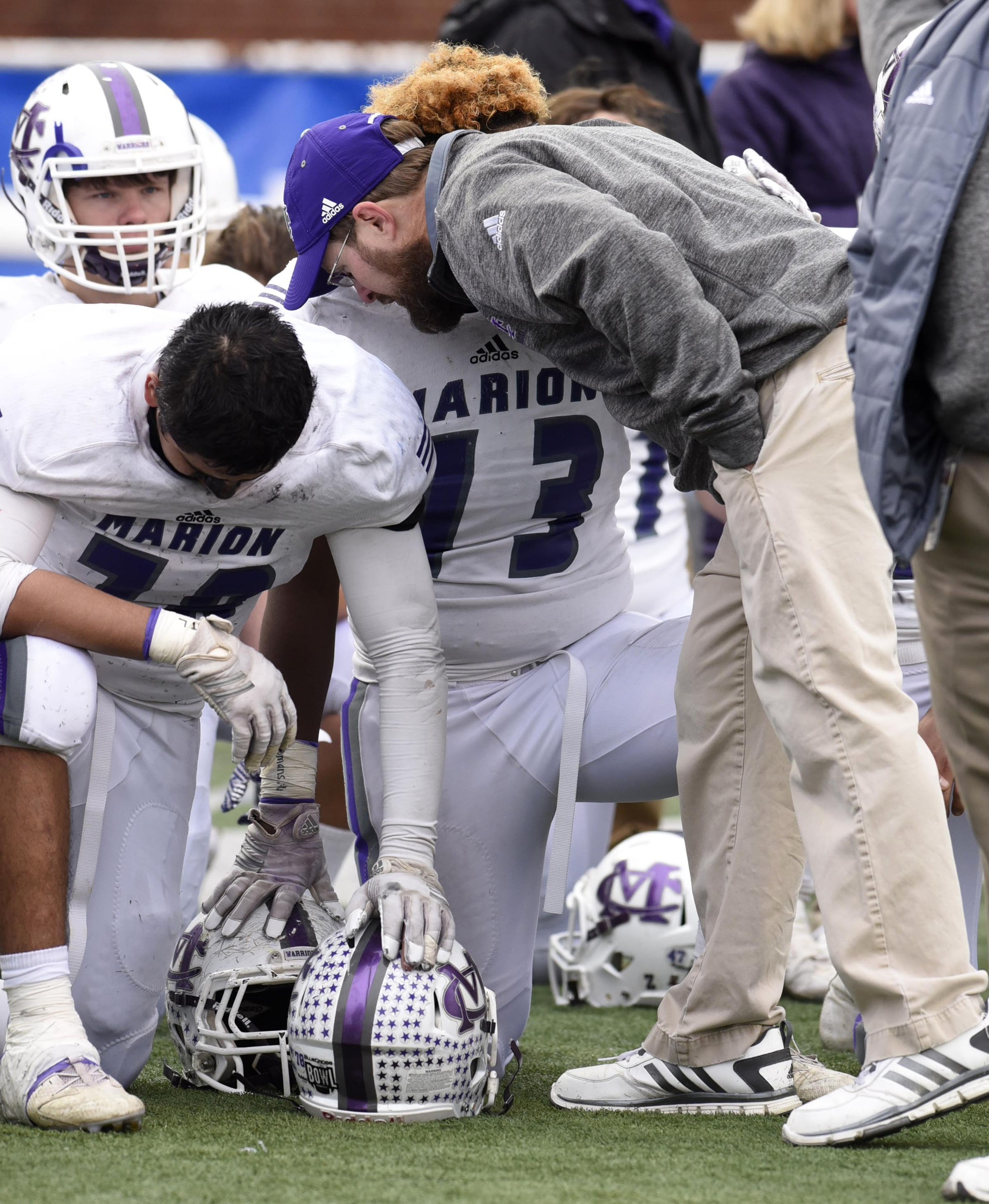 Marion County head coach Joe Mathis consoles Cory Tucker (73) and Ismael Avila (78). The Marion County Warriors faced the Memphis Trezevant Bears in the Class AA TSSAA State Football Championship played in the BlueCross Bowl at Tennessee Tech in Cookeville on December 3, 2016.