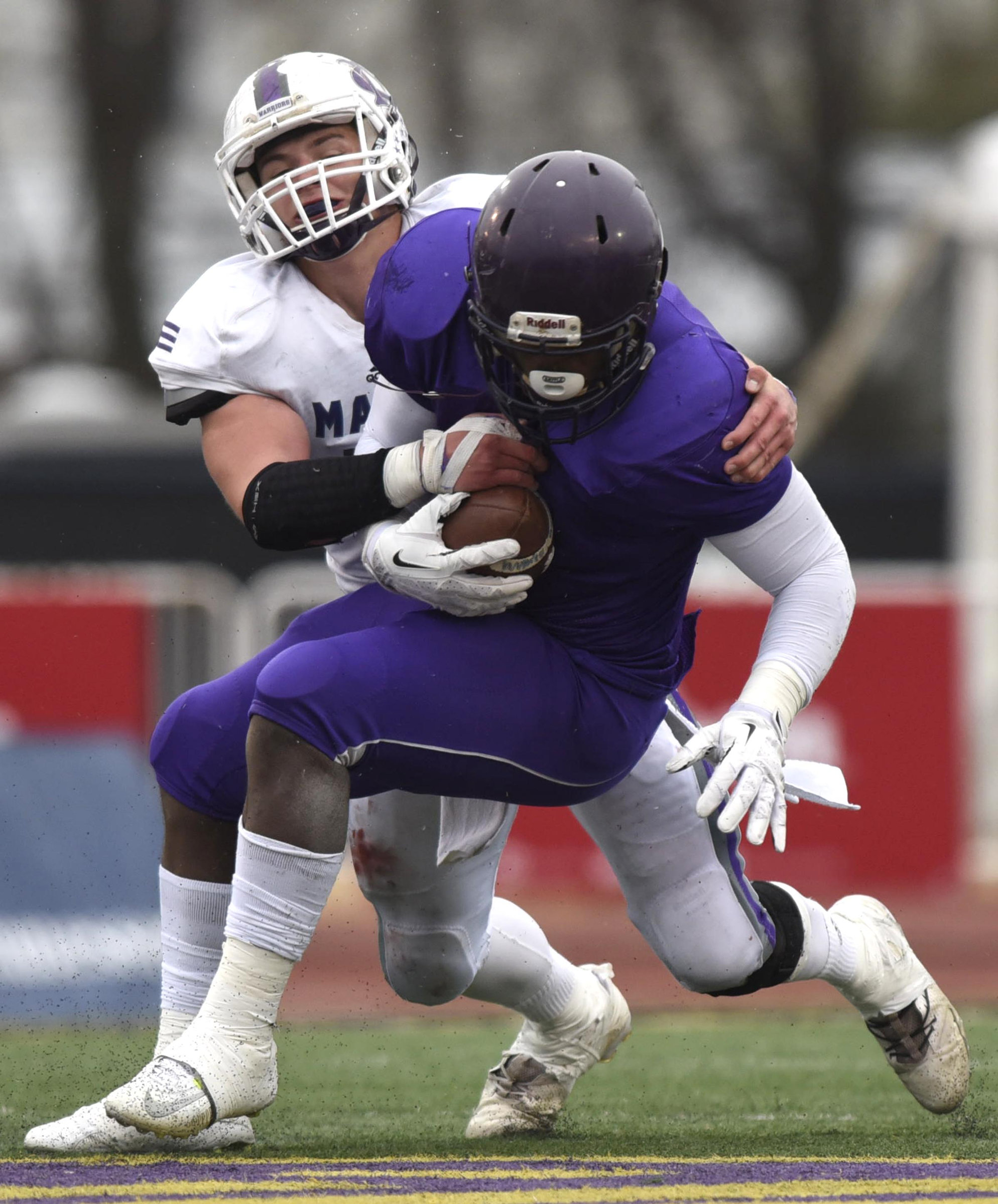 Marion County's Alex Kirkendoll (17) stops Trezevant's Cordarrian Richardson (5) on fourth down. The Marion County Warriors faced the Memphis Trezevant Bears in the Class AA TSSAA State Football Championship played in the BlueCross Bowl at Tennessee Tech in Cookeville on December 3, 2016.