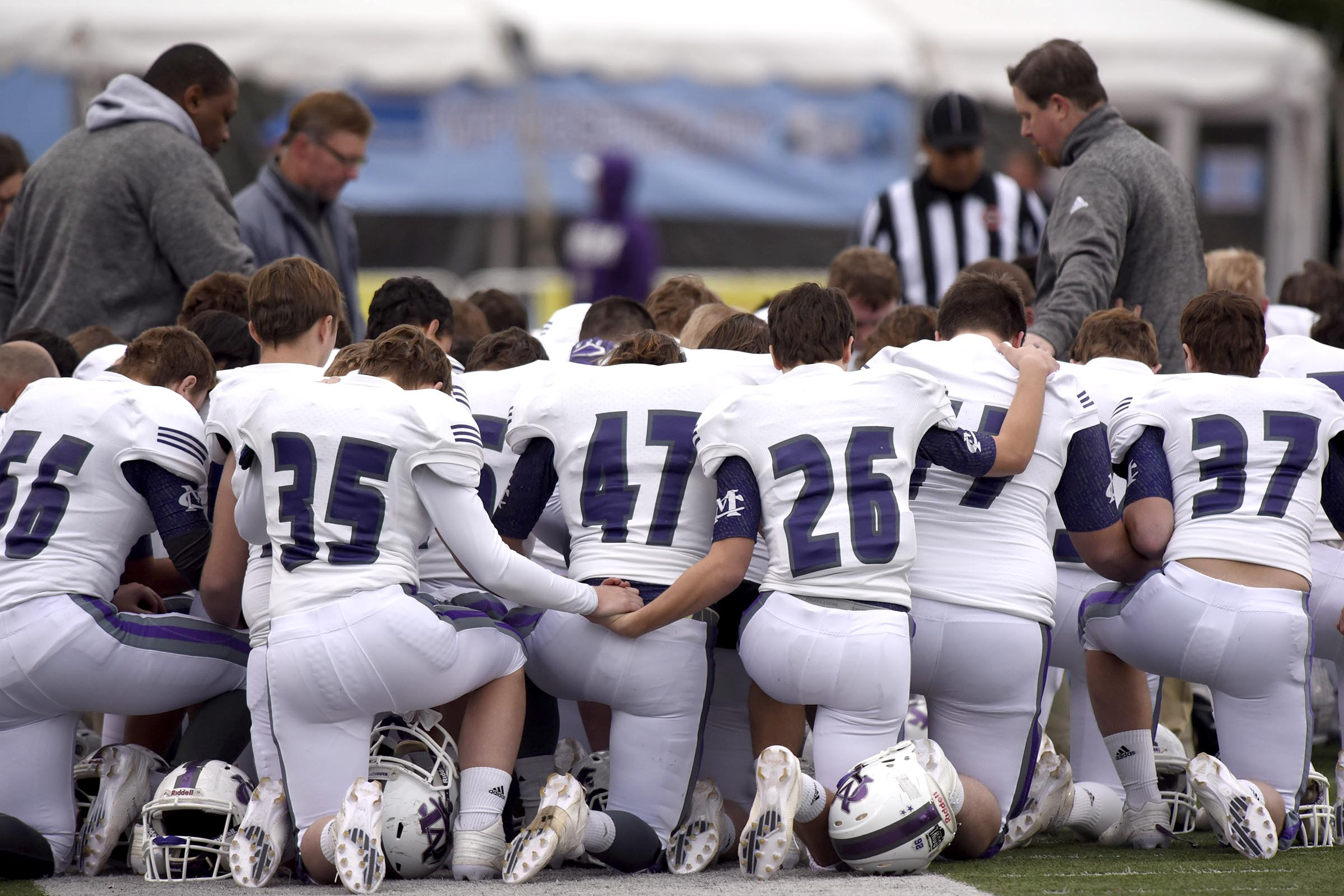 Marion County prays as teammate Hunter Zeman is attended to on the field. The Marion County Warriors faced the Memphis Trezevant Bears in the Class AA TSSAA State Football Championship played in the BlueCross Bowl at Tennessee Tech in Cookeville on December 3, 2016.