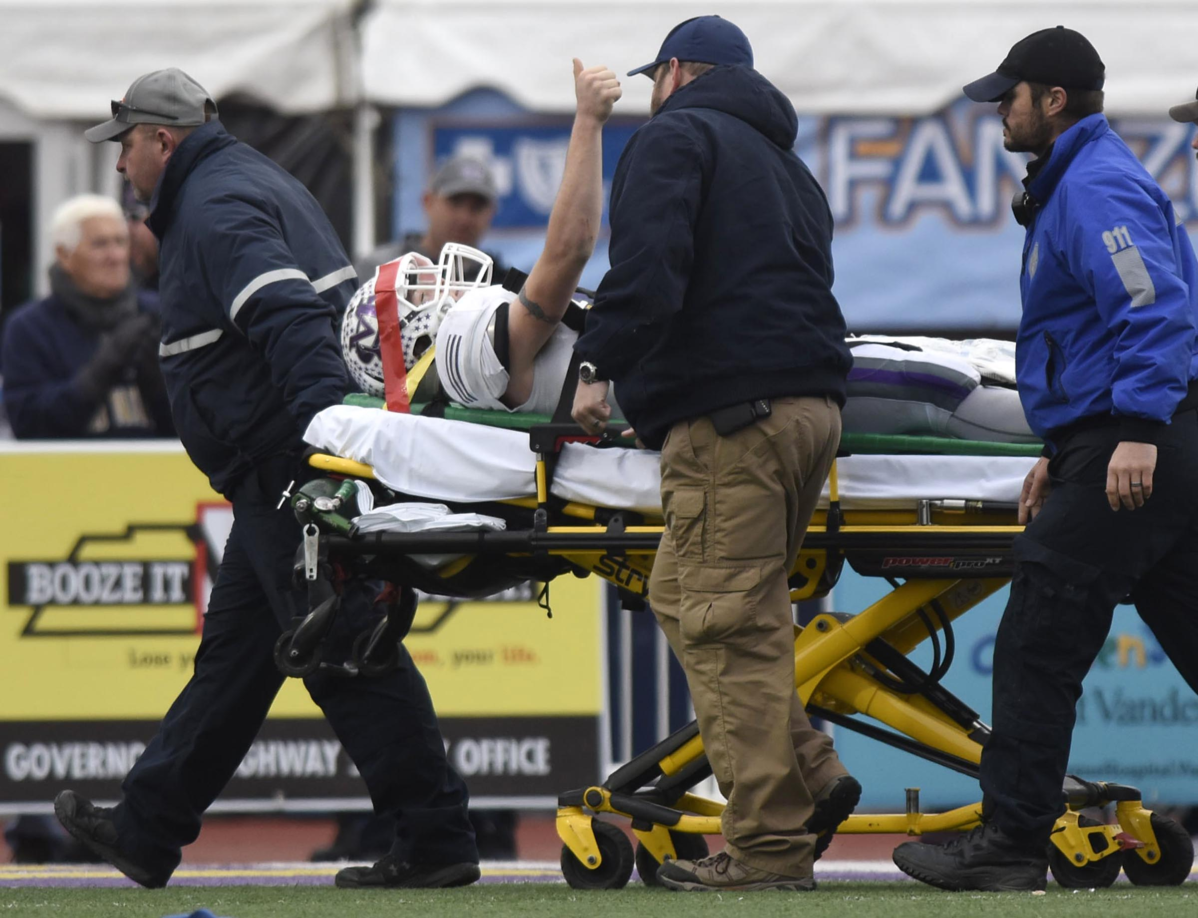 Marion County's Hunter Zeman (11) gives the crowd a thumbs up as he is taken from the field to an ambulance with a severe injury. The Marion County Warriors faced the Memphis Trezevant Bears in the Class AA TSSAA State Football Championship played in the BlueCross Bowl at Tennessee Tech in Cookeville on December 3, 2016.