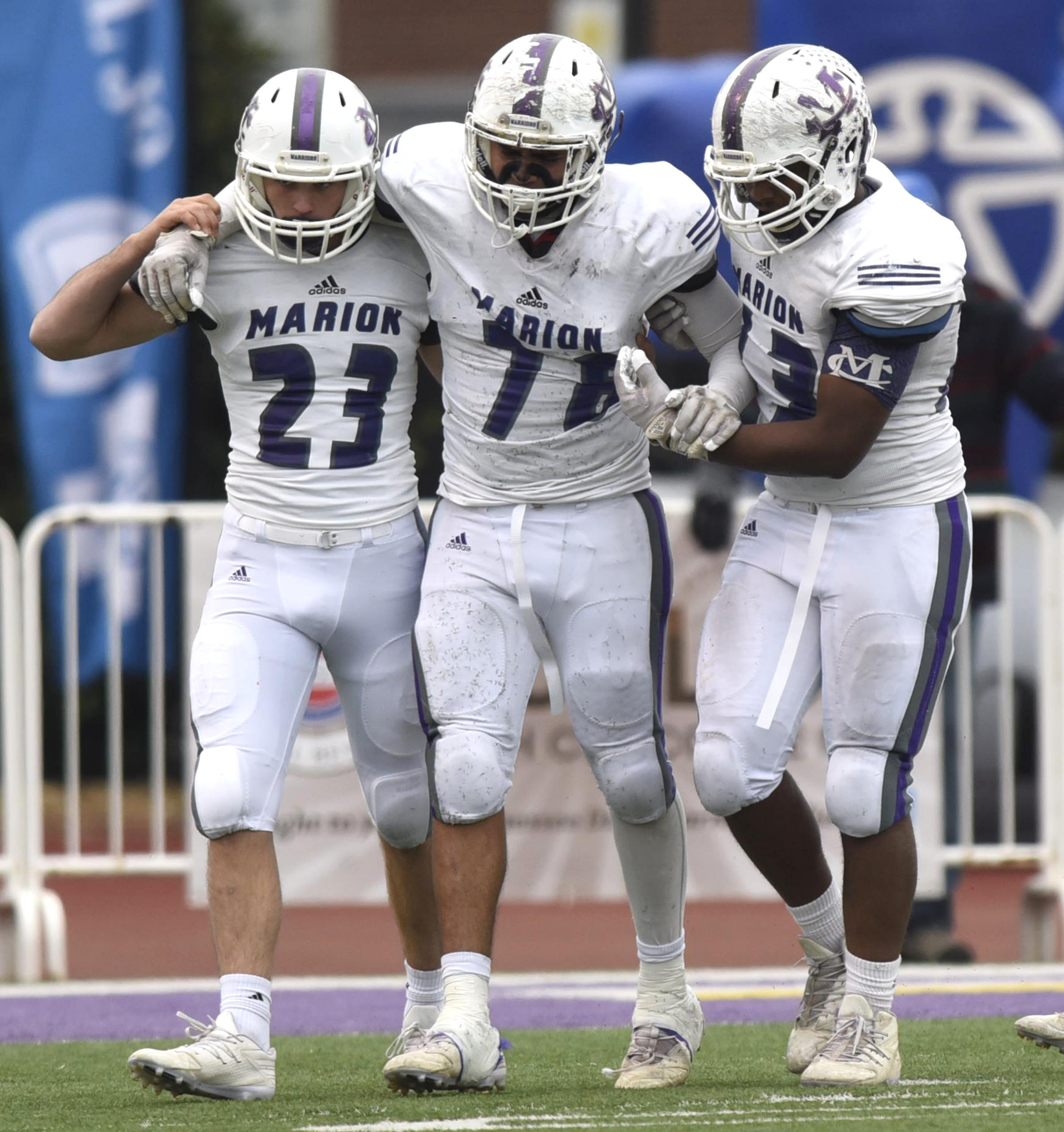 Marion County's Ismael Avila (78) is helped from the field by Guy Hansard (23) and Cory Tucker (73). The Marion County Warriors faced the Memphis Trezevant Bears in the Class AA TSSAA State Football Championship played in the BlueCross Bowl at Tennessee Tech in Cookeville on December 3, 2016.