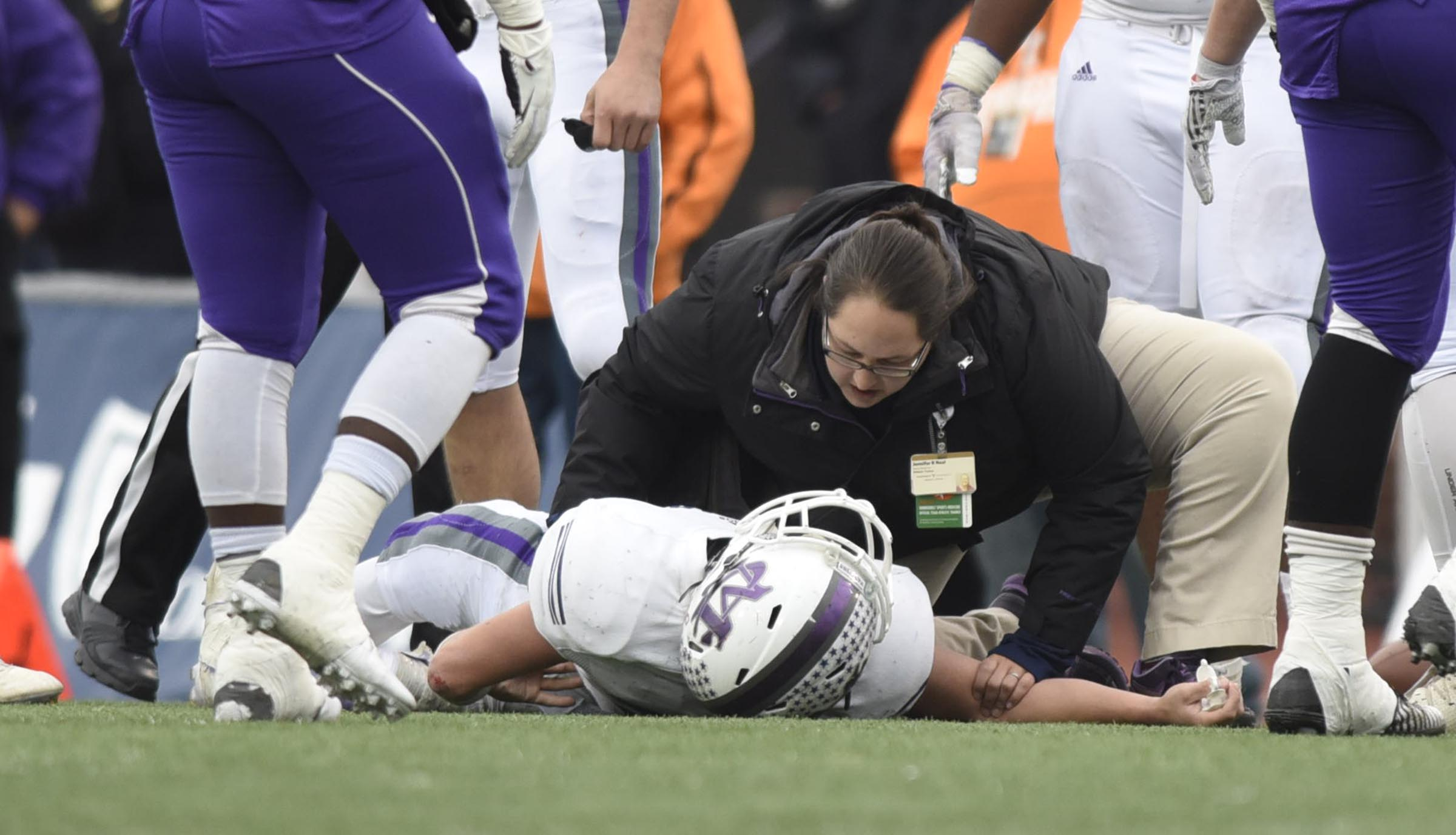 Marion County's Cory Murray (34) is attended to after he suffered a severe injury and had to be taken from the field and transported to a hospital. The Marion County Warriors faced the Memphis Trezevant Bears in the Class AA TSSAA State Football Championship played in the BlueCross Bowl at Tennessee Tech in Cookeville on December 3, 2016.