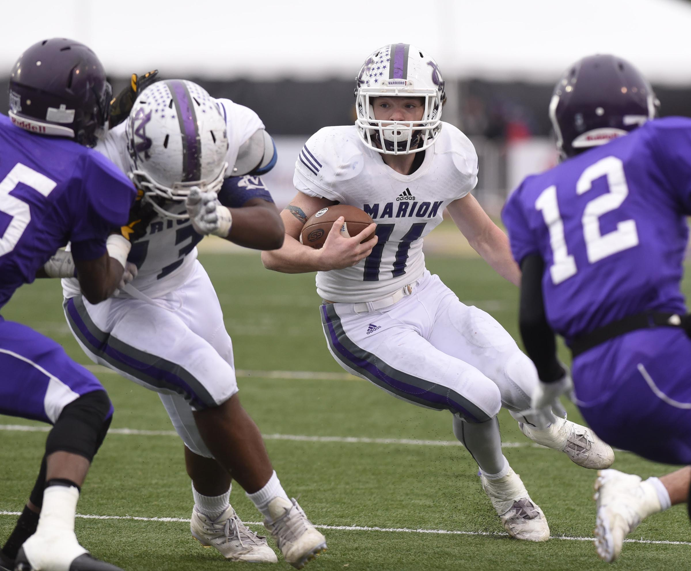 Marion County's Hunter Zeman (11) looks for running room as he follows the blocking of Cory Tucker (73). The Marion County Warriors faced the Memphis Trezevant Bears in the Class AA TSSAA State Football Championship played in the BlueCross Bowl at Tennessee Tech in Cookeville on December 3, 2016.