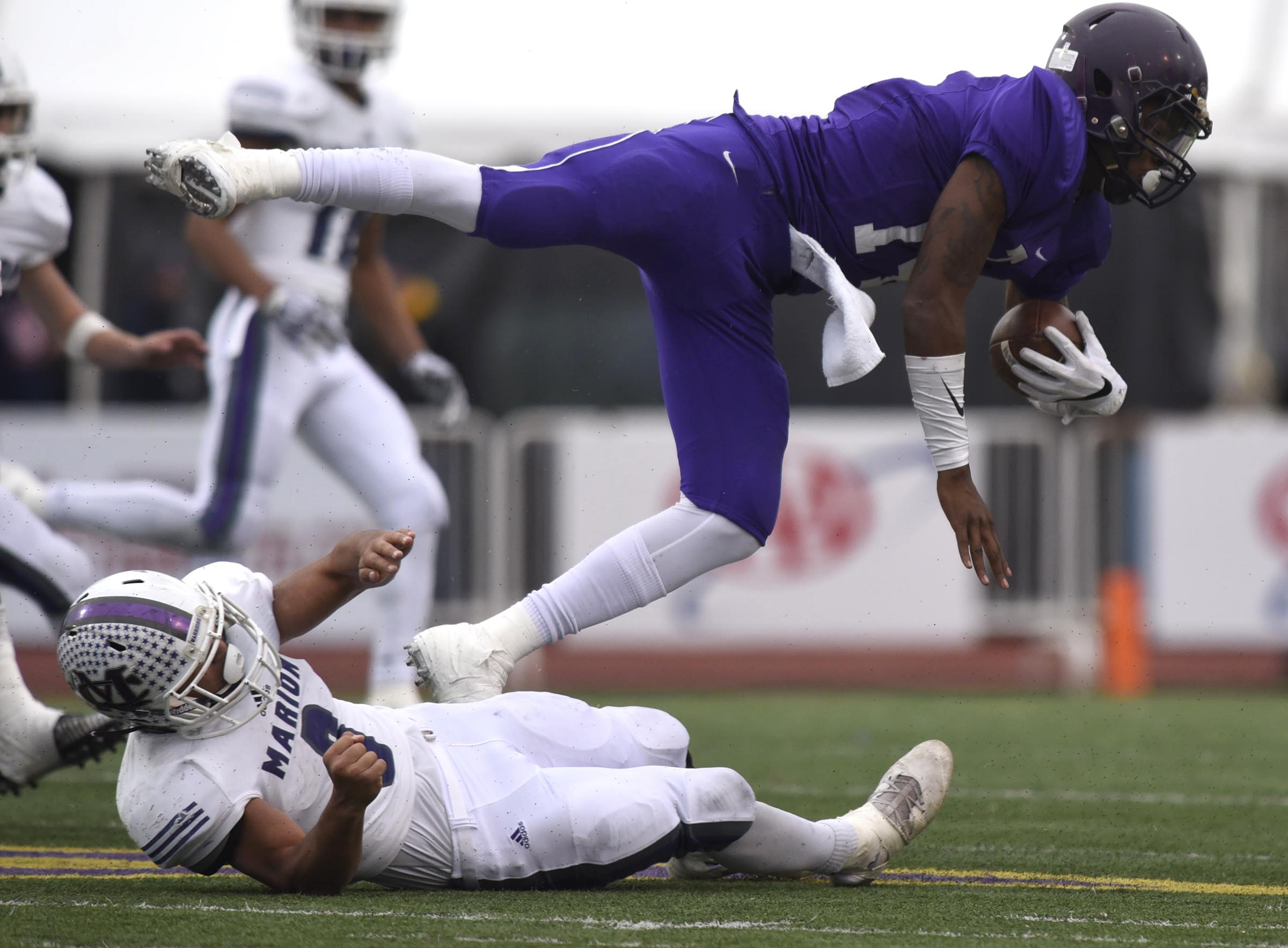 Marion County's Jacob Saylors (8) upends Trezevant quarterback Tywon Johnson (14). The Marion County Warriors faced the Memphis Trezevant Bears in the Class AA TSSAA State Football Championship played in the BlueCross Bowl at Tennessee Tech in Cookeville on December 3, 2016.